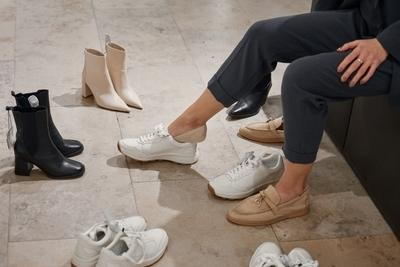 Person trying on various footwear options for better foot care