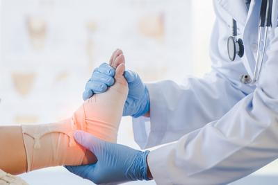 Foot-of-patient-adjusted-by-the-doctor-in-clinic.