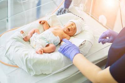 Pediatrician monitoring and supporting the health of a preterm newborn