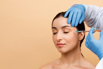 Woman's face infected by Acne with redness.