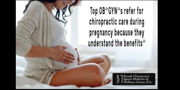 Happy pregnant woman dressed in white, with her hands on her abdomin. The words" Top OB/Gyns refer for chiropractic care during pregnancy because they understand the benefits"