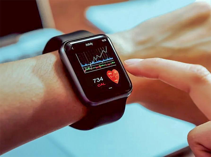 Person looking at their smart watch after exercising in Cary, NC