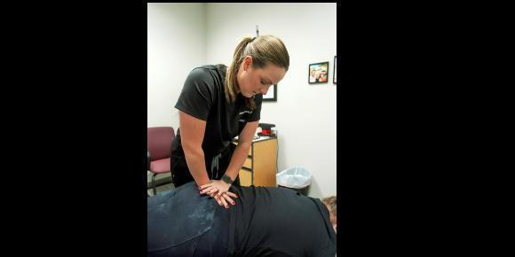 Dr Abbie Swank treats patient with spinal manipulation
