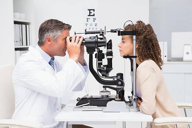 A doctor doing eye exam with a female patient