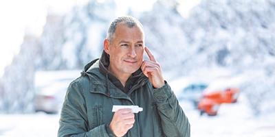Smiling-Man-Applying-Sunscreen-to-His-Cheeks