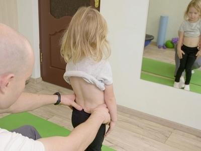 Doctor-in-clinic-check-the-back-of-a-little-girl.