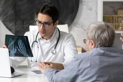 Doctor analyzing the result of xray with patient