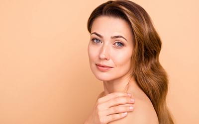 Woman-with-Glowing-Skin-Touching-Shoulder-Softly