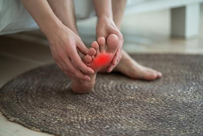 Man-Holding-His-Painful-Foot