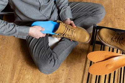Man using custom orthotics for foot support in boots