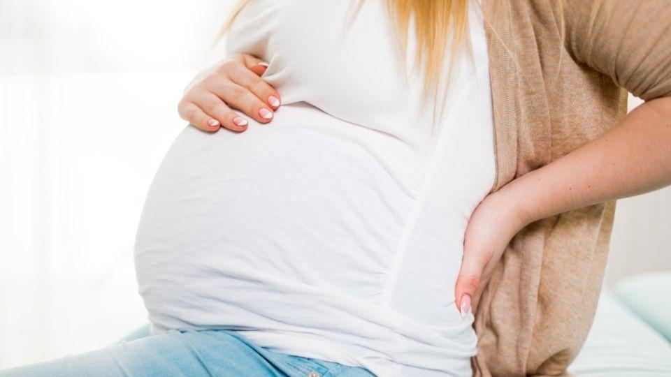 Pregnant Women Holding Her Belly