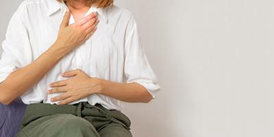 Female patient experiencing severe abdominal discomfort and acid reflux.