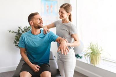Man receiving manual chiropractic therapy on treatment table