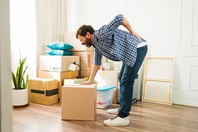 Man with back injury caused by lifting heavy object