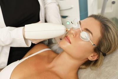 Woman is under IPL Treatment Procedure.