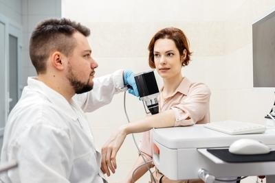 Doctor using dermatoscope to examine skin for cancer