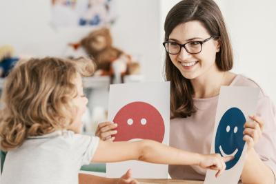 Child choosing in two images show by a woman therapist.
