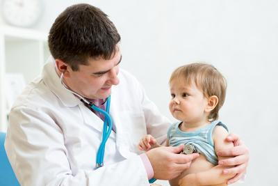 Little boy in doctor's clinic checking by the pediatrician.