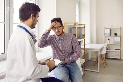 Man-Suffering-from-Chronic-Migraine-Visits-Doctor