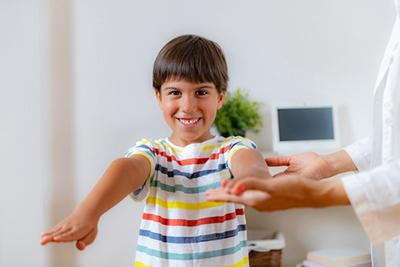 Young boy with the doctor on clinic for physical exam