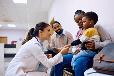 Family-Doctor-holds-Child's-Hand