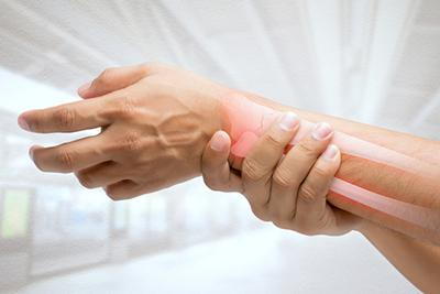 Person-holding-painful-wrist-with-bone-illustration.