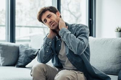 Illustration of Neck pain on man sitting on sofa
