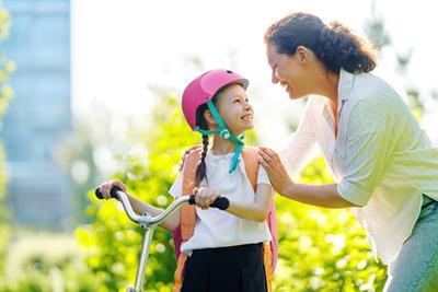 Girl-Wearing-Helmet-Before-Riding-a-Bike-to-School