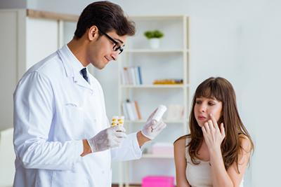 Woman consulting a dermatologist about acne and oral medications.