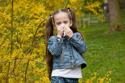 Young girl sneezing outdoor