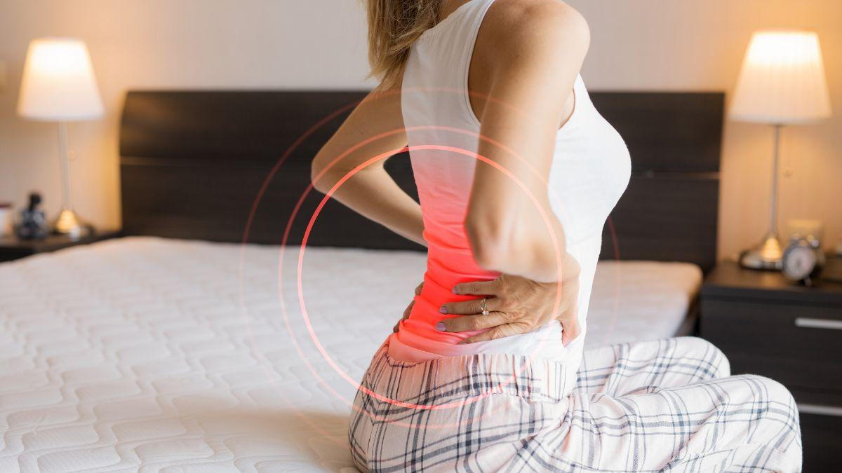 A Woman Holding Her Back Due To Back Pain