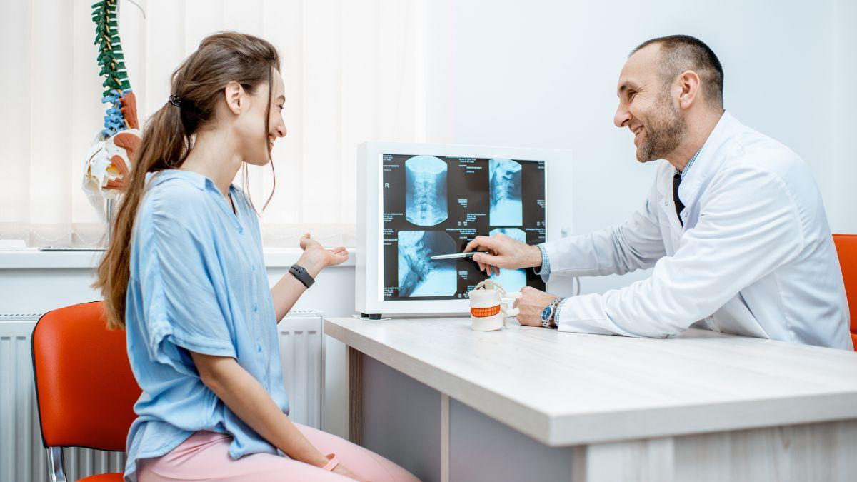 Patient And Physician Examining A Digital X-Ray