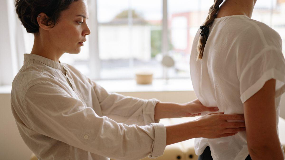 Back Pain In Female Patients Being Examined By A Pain Expert