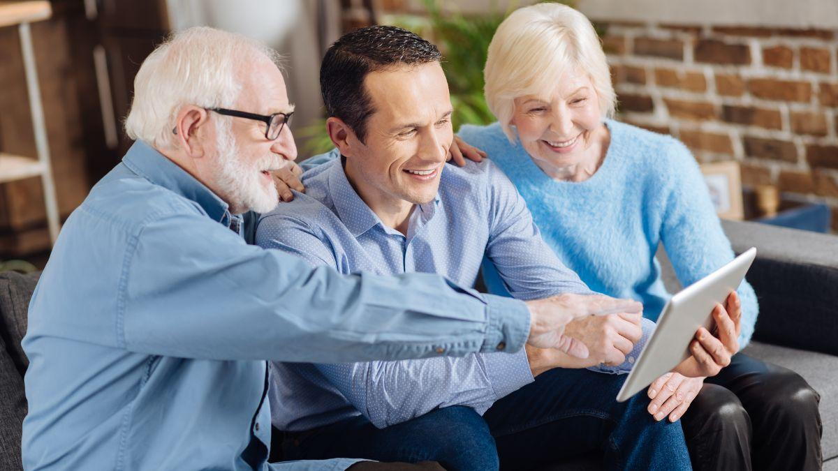 Group Of People Looking At A Tablet