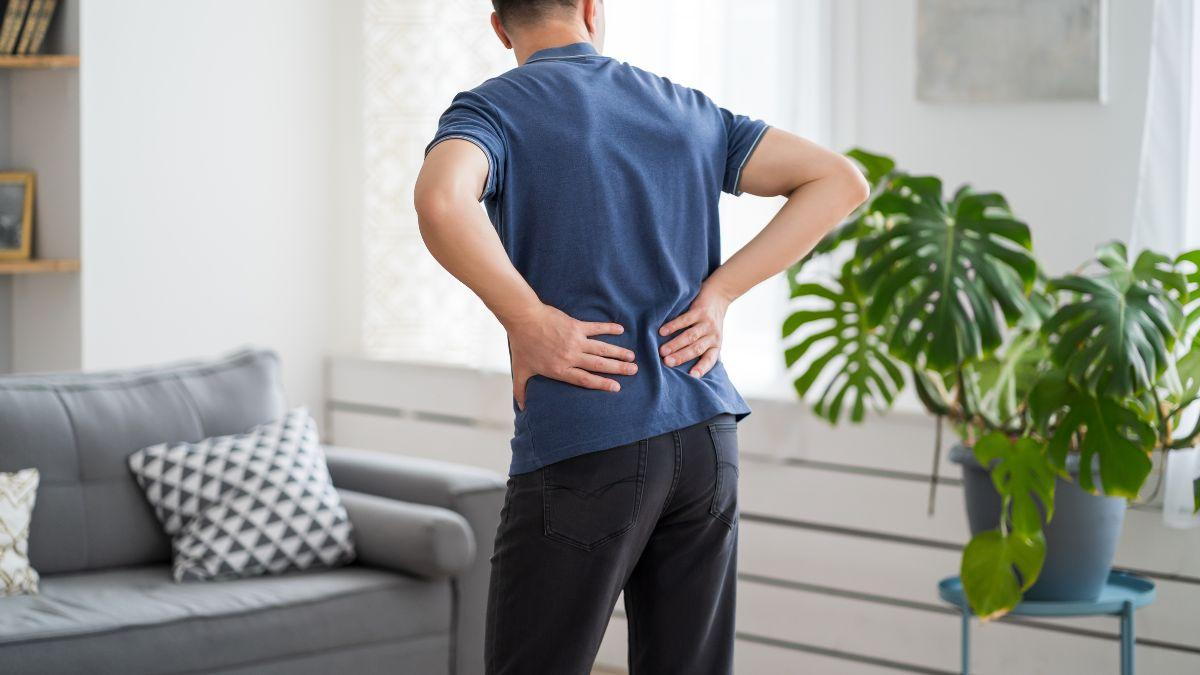 Man Holding His Back Due To Back Pain