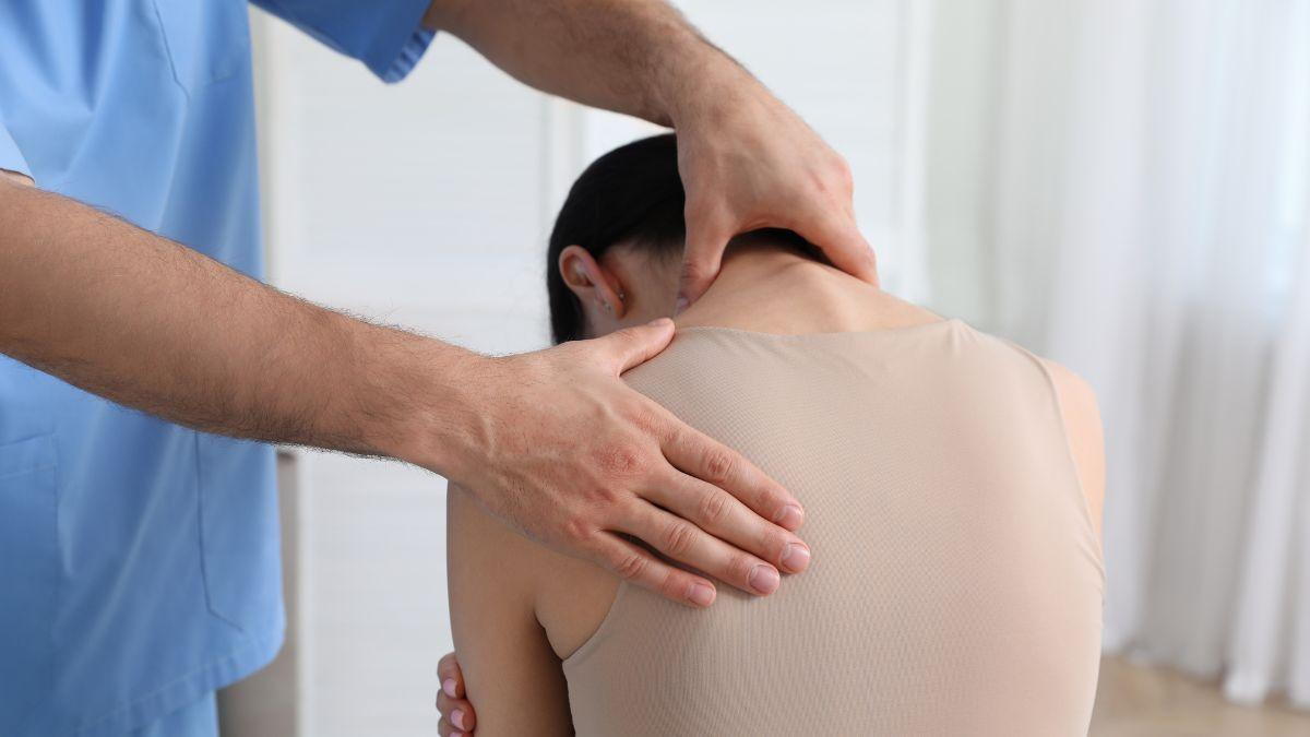 Expert Diagnosing A Woman's Back