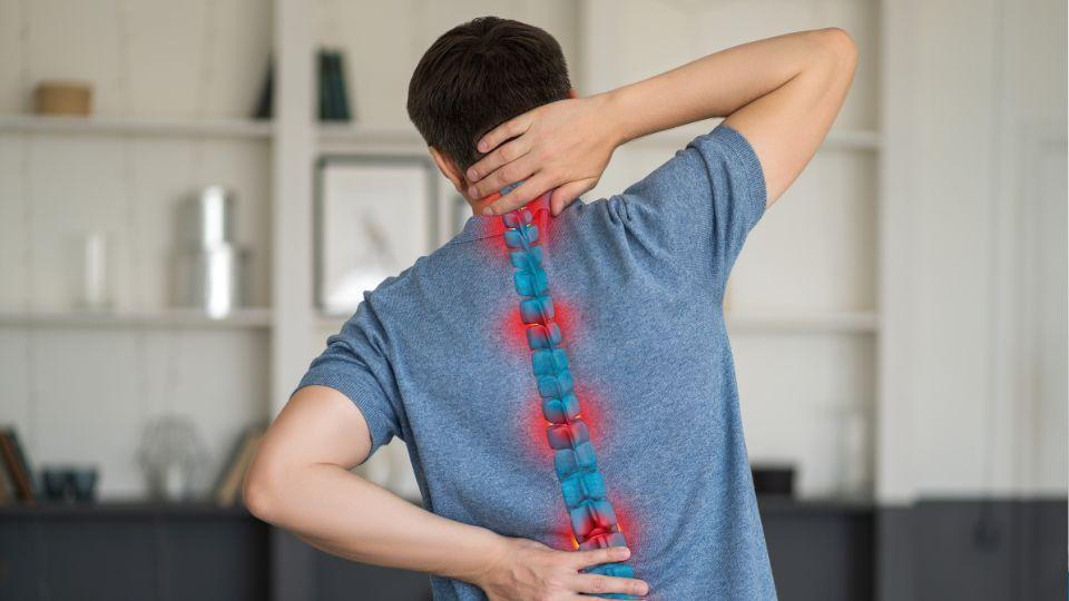 Man Holding His Neck And Lower Back Due To Pain