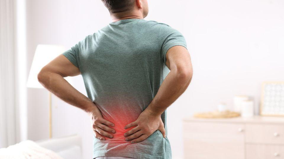 Man Holding His Lower Back In Pain