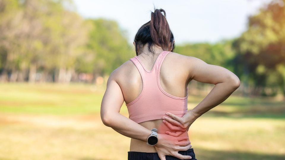 Woman Holding Her Lower Back In Pain