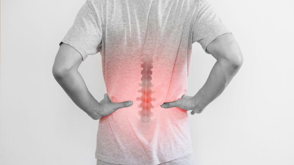 Man Holding His Lower Back Due To Back Pain