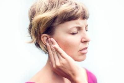 Woman-experiencing-ear-pain-while-sitting