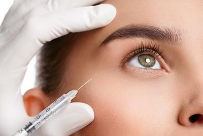 Injecting Botox in woman's lower eye