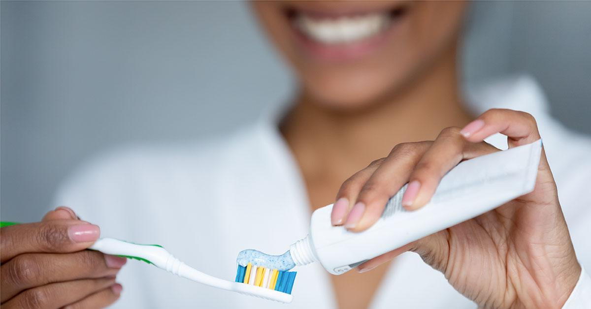 woman practicing good dental hygiene with a toothbrush and toothpaste