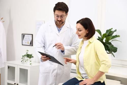 Doctor reviewing routine screening results with a female patient during a clinic visit