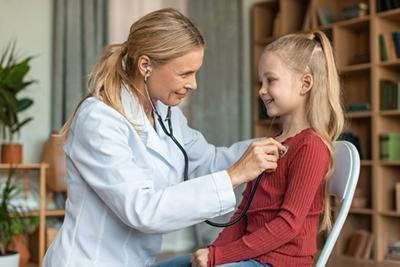Doctor checking the beat of the young girl on clinic