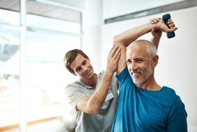 Physiatrist-and-Mature-Man-With-Dumbbell