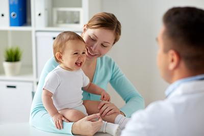 Doctor looking at the little boy together with the mother.