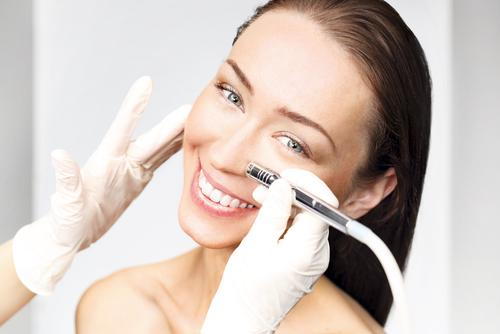 Woman receiving a microdermabrasion facial treatment