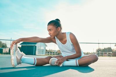 Athletic-Woman-Doing-Cool-Down-Exercises-After-Running