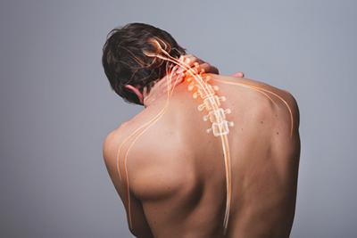Man experiencing sharp neck pain from a compressed cervical nerve.